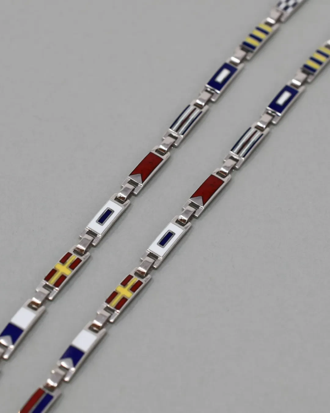 Bracciale uomo bandierine oro bianco